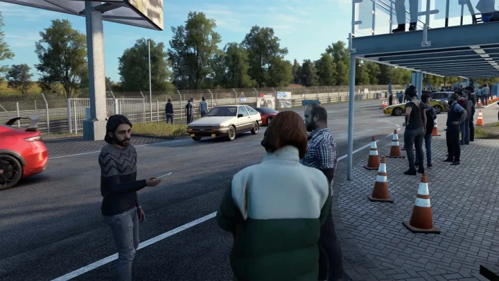 Assetto Corsa EVO serbest sürüş alanında araçların ve yayaların bulunduğu bir yol kenarı sahnesi