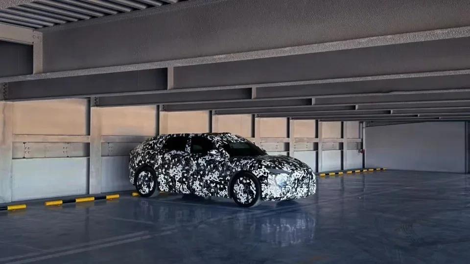 Kapalı bir alanda kamuflaj desenli bir Faraday Future aracı