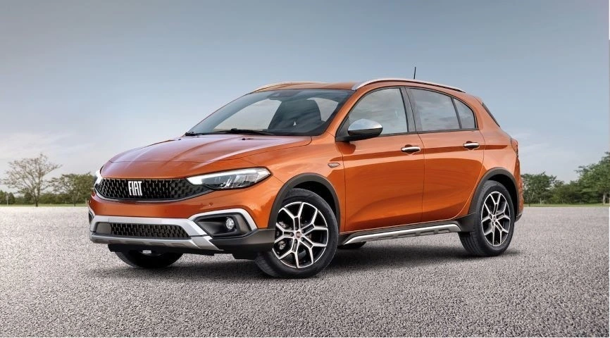 Açık alanda duran turuncu Fiat hatchback otomobil