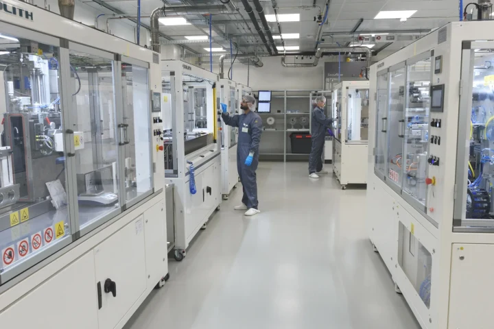 Fraunhofer ISE’nin pilot üretim hattında çalışan araştırmacılar ve batarya üretim ekipmanları