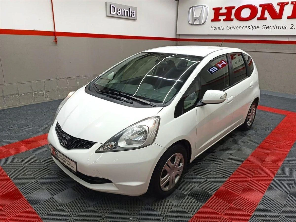 Beyaz Honda Jazz hatchback, kapalı bir alanda sergileniyor