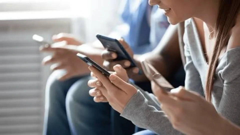Toplu taşıma benzeri bir ortamda telefonlarını kullanan kişiler