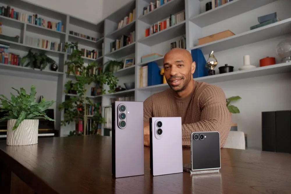 Thierry Henry, Samsung Galaxy Z serisi katlanabilir telefonlarla bir masanın arkasında oturuyor