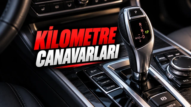 Otomobilin orta konsolundaki otomatik vites kolu ve kilometre dayanıklılığına vurgu yapan yazı